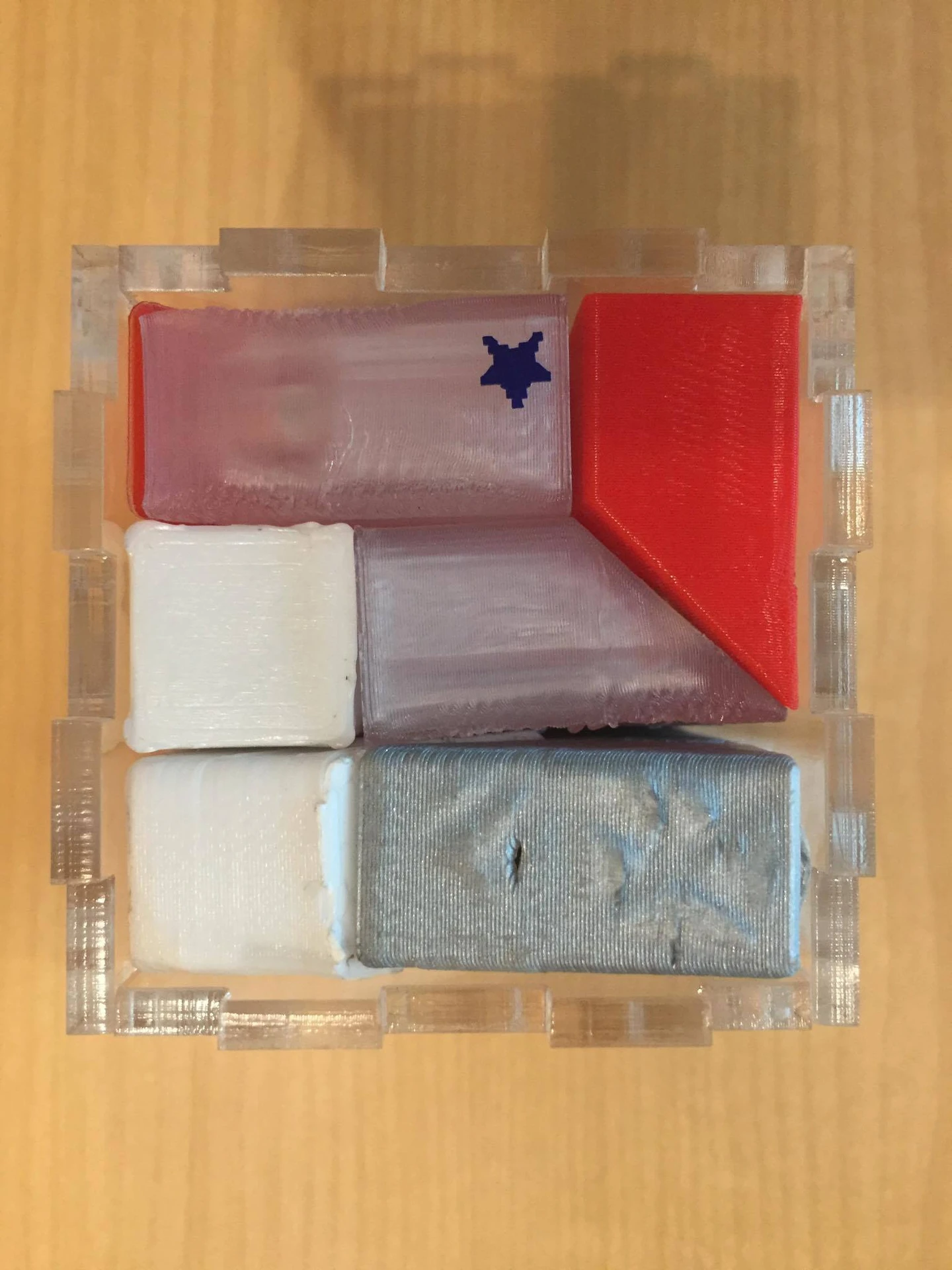 Close-up of pieces arranged inside the acrylic cube