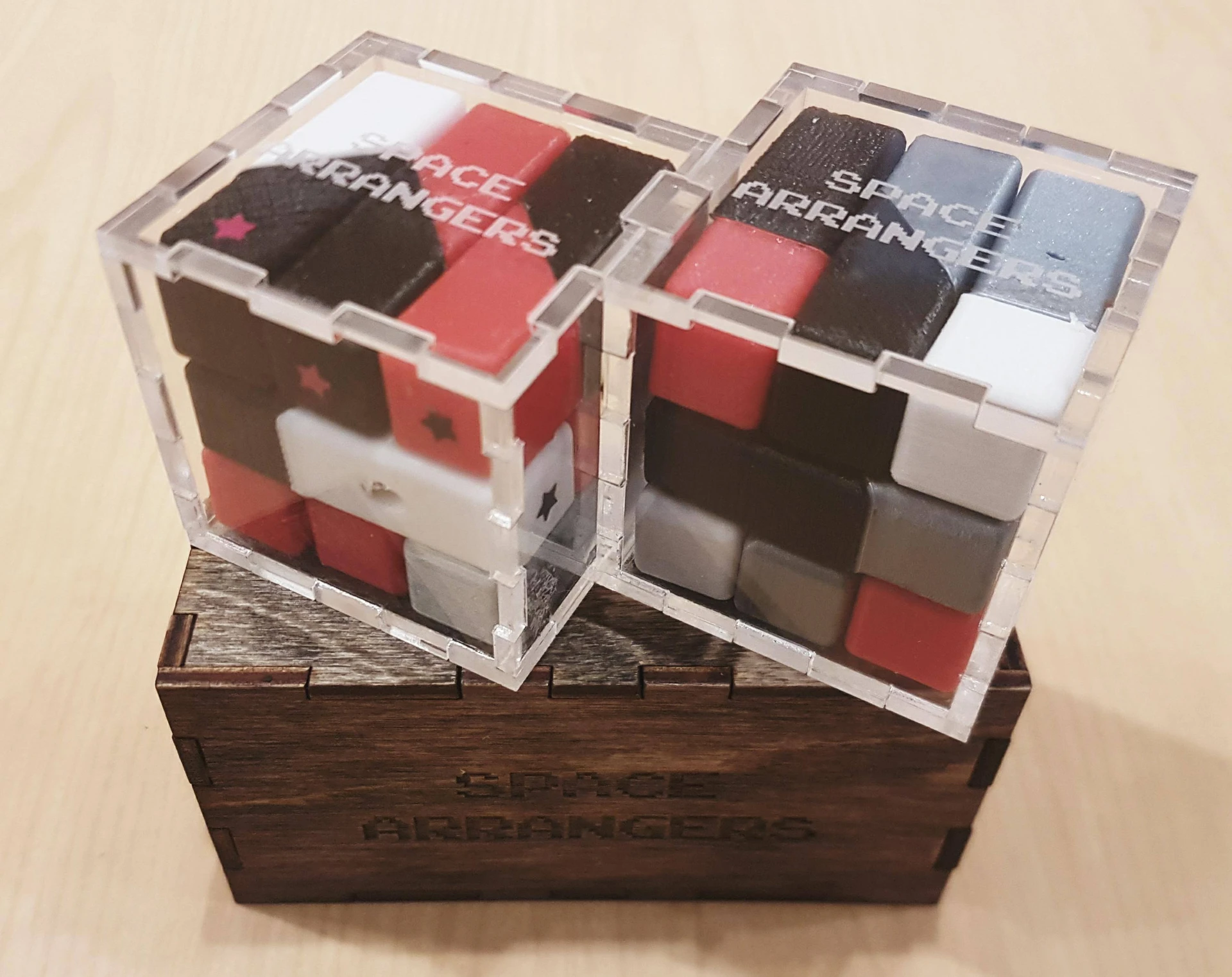 Two completed Space Arrangers cubes on the game box