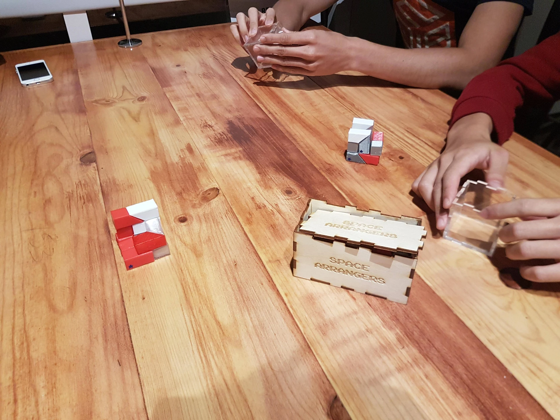 Players mid-game at a wooden table